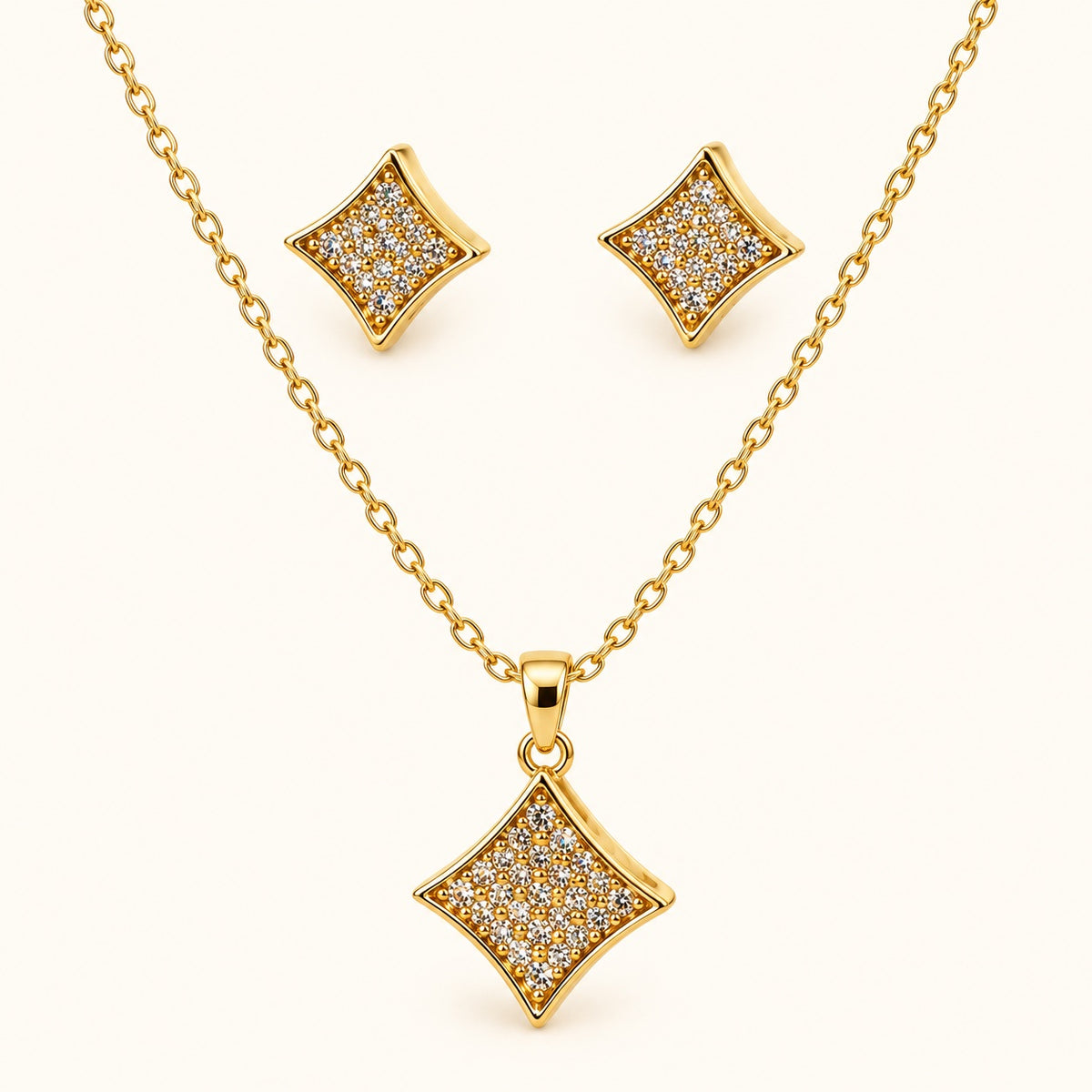Front view of gold-tone pavé rhombus pendant necklace with matching stud earrings