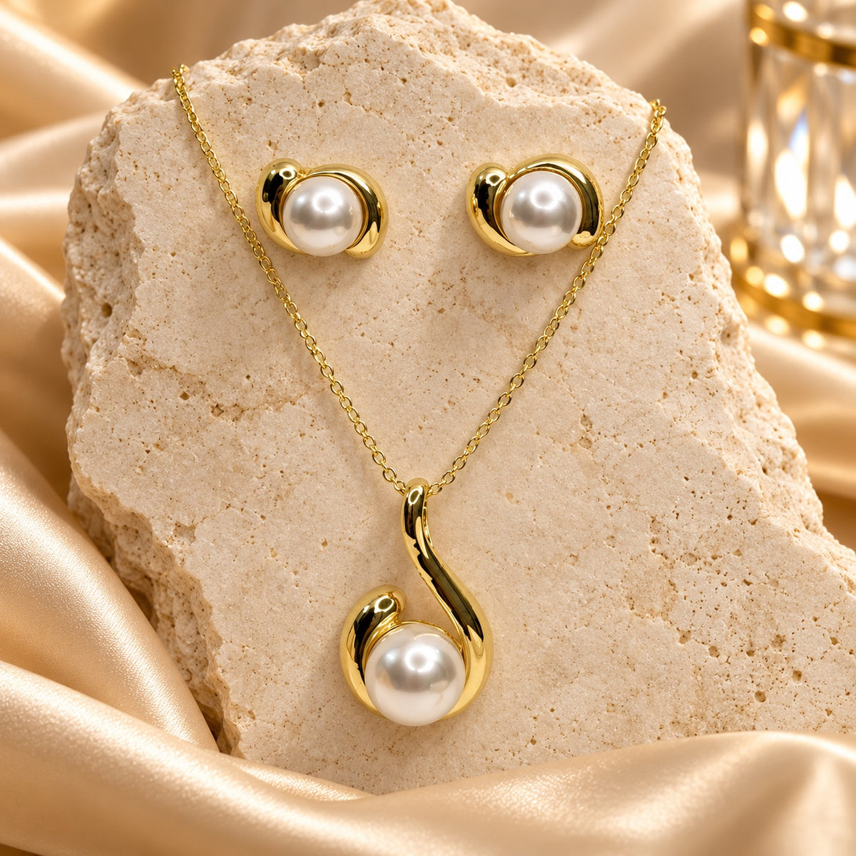 Pearl Swirl Necklace Set in gold tone with faux pearl pendant and matching studs on stone