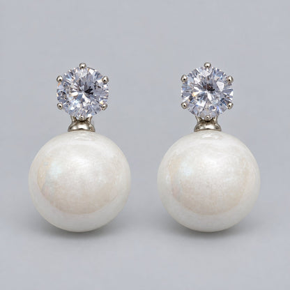 Front view of pearl white lustre orb drop earrings with cubic zirconia tops