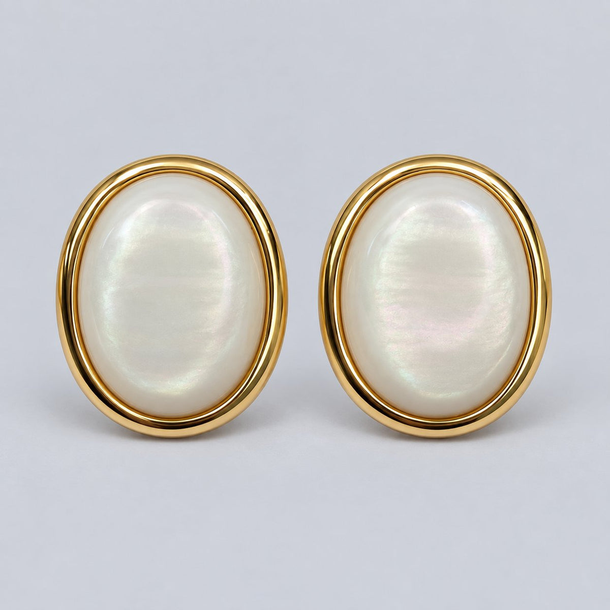 Front view of gold-tone pearlescent oval dome stud earrings