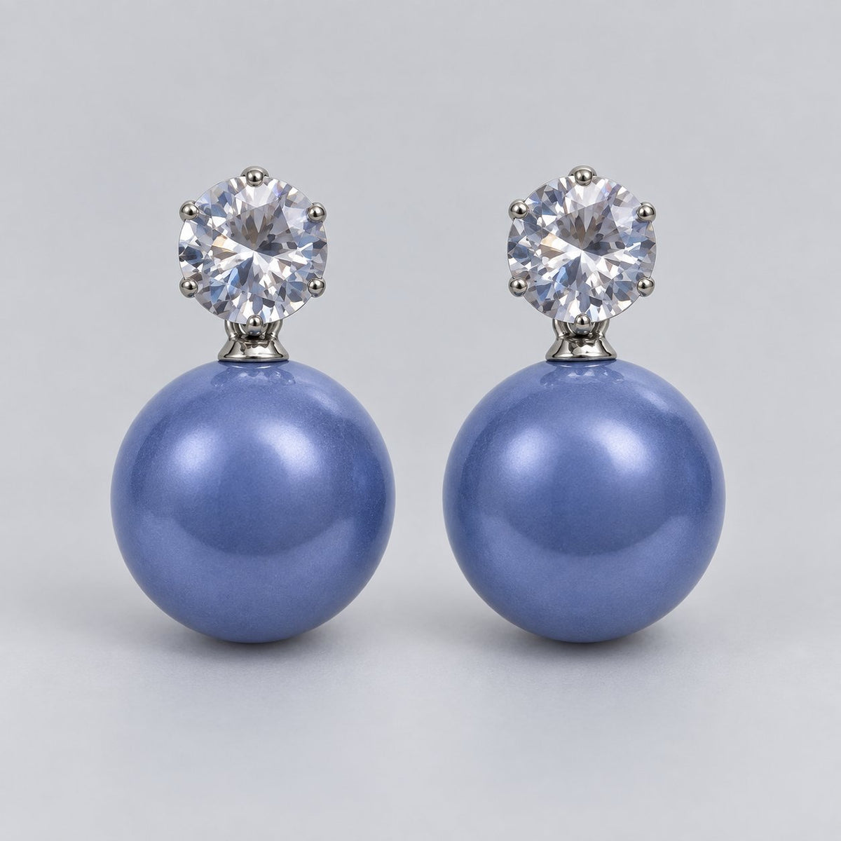 Front view of periwinkle blue lustre orb drop earrings with cubic zirconia tops