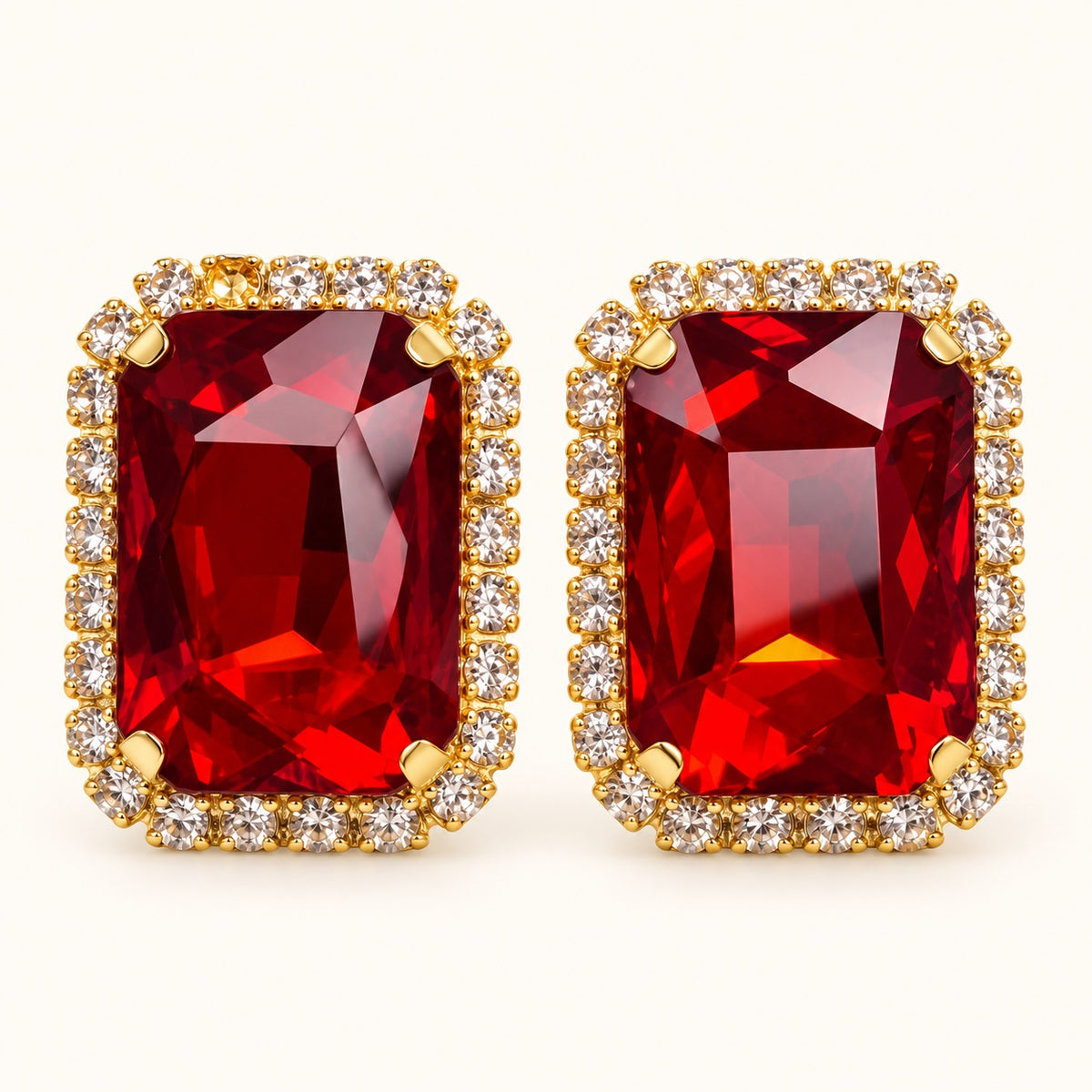 Front view of Regal Ruby Red Halo Studs with ruby red emerald-cut stone and cubic zirconia halo