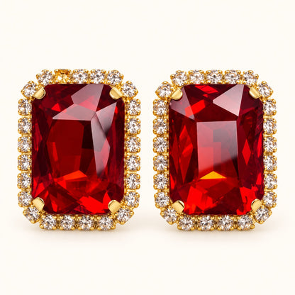 Front view of Regal Ruby Red Halo Studs with ruby red emerald-cut stone and cubic zirconia halo