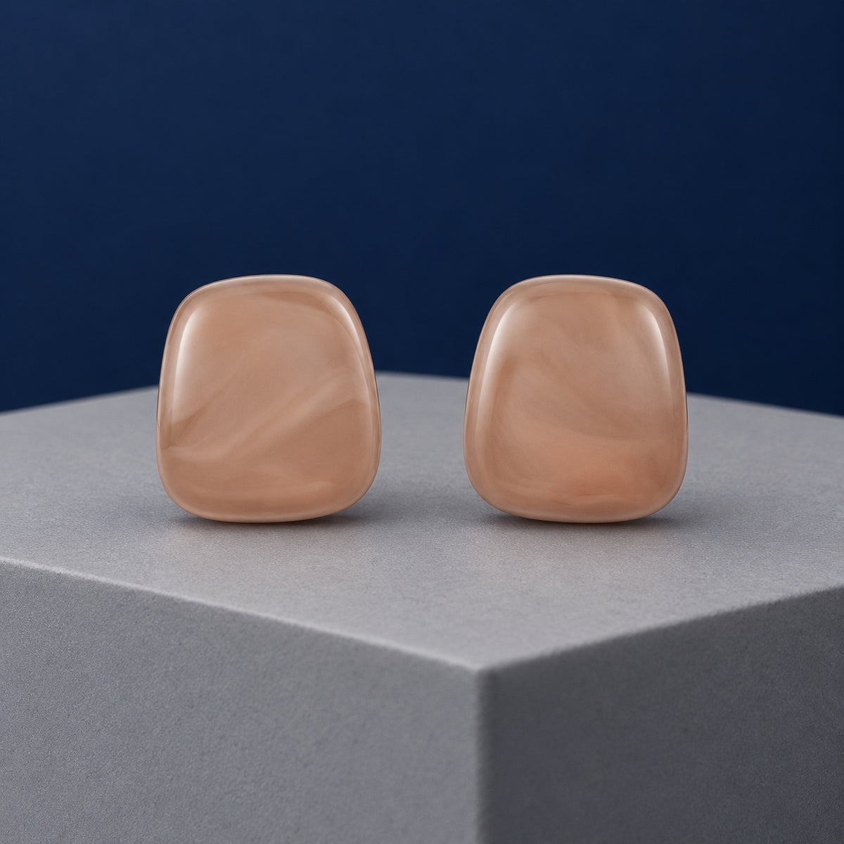 Rose Petal Cabochon Studs soft blush cushion stud earrings on a grey pedestal