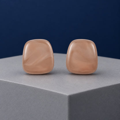 Rose Petal Cabochon Studs soft blush cushion stud earrings on a grey pedestal