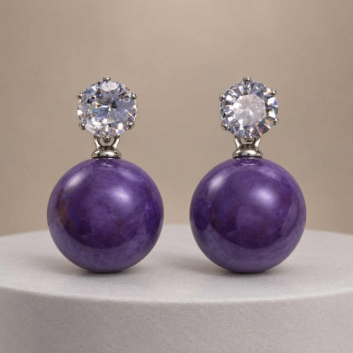 Royal Purple Lustre Orb Drops silver-tone earrings with sparkling top stones and glossy royal purple orbs on a pale pedestal
