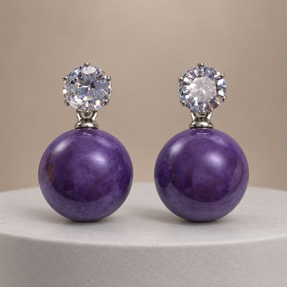 Royal Purple Lustre Orb Drops silver-tone earrings with sparkling top stones and glossy royal purple orbs on a pale pedestal
