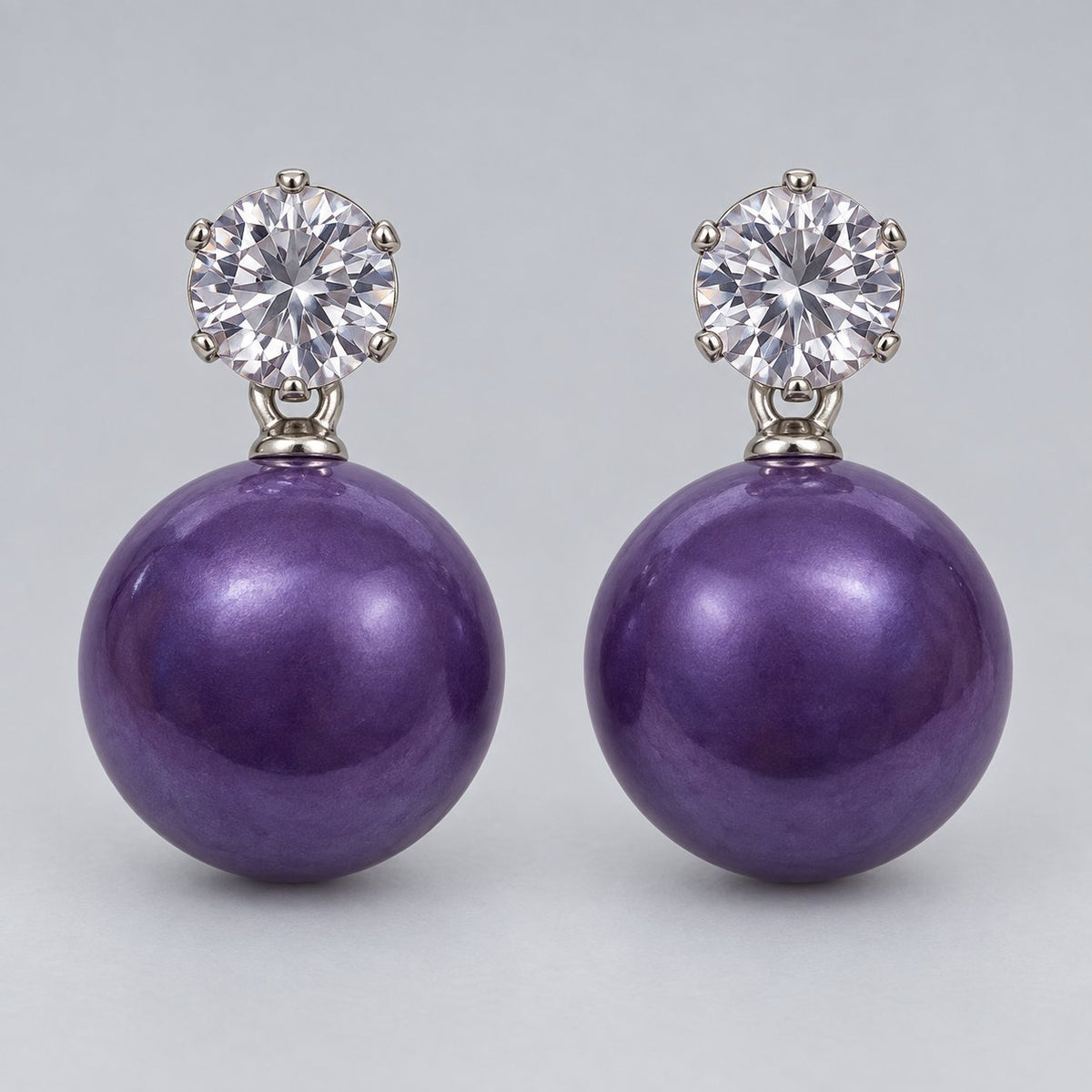 Front view of royal purple orb drop earrings with sparkling round top stones