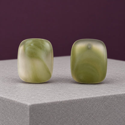 Sage Mist Cabochon Studs frosted sage green cushion stud earrings on a grey pedestal
