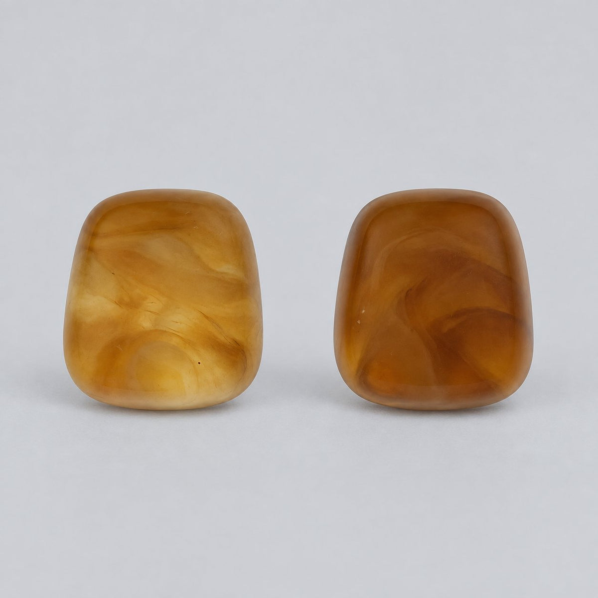 Front view of sunlit amber cushion cabochon stud earrings