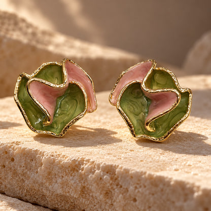 Verdant Rose Enamel Studs gold-tone earrings with ruffled green and pink enamel petals on a sandstone block